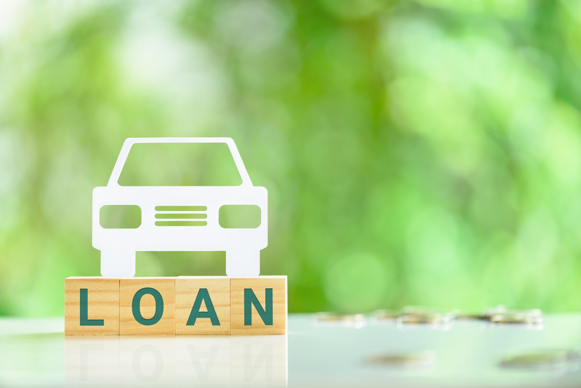 Car or auto loan, financial concept : Sedan car on wood blocks with the word LOAN.